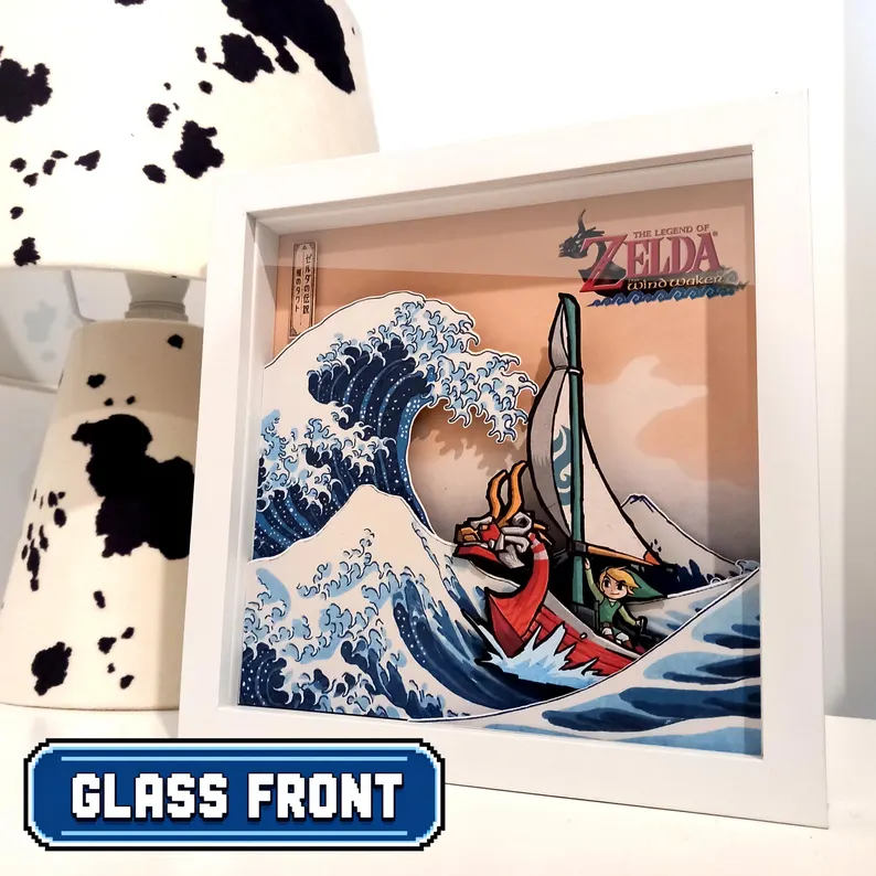 Front view of a white-framed Wind Waker shadow box showing Link and the King of Red Lions sailing through a layered Great Wave.