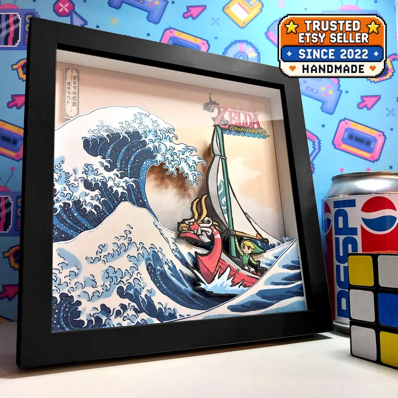 Angled view of a black-framed Wind Waker shadow box showing Link and the King of Red Lions beside a layered Great Wave.