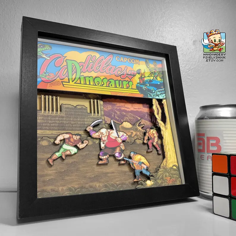 Black-framed Cadillacs and Dinosaurs layered pixel art shadow box
