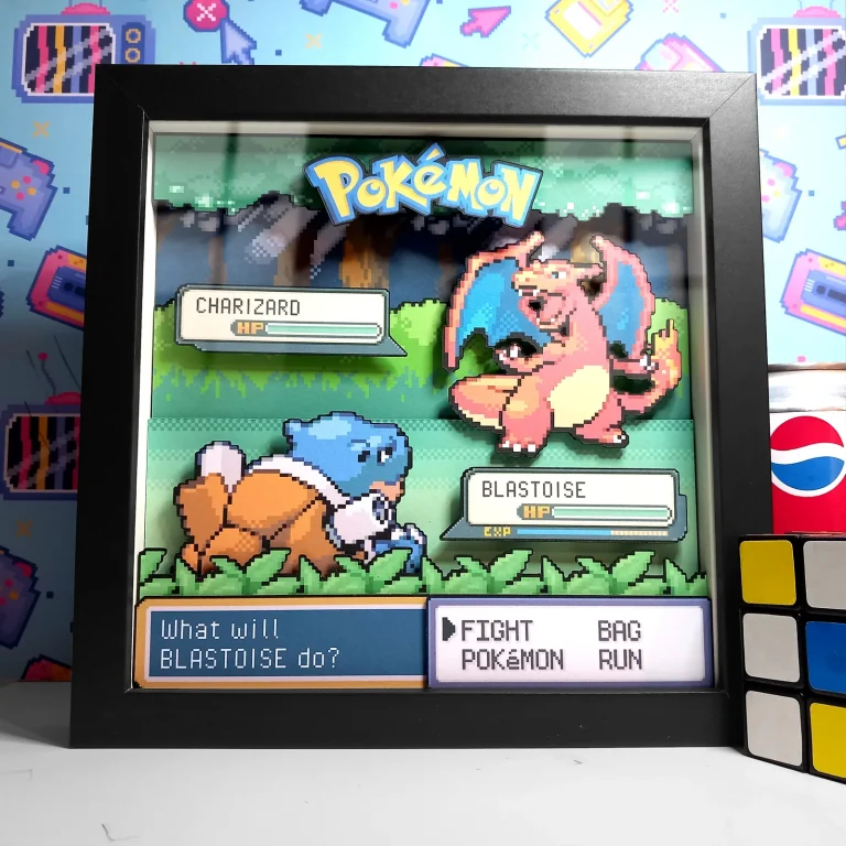 Black-framed custom Pokémon battle shadow box showing Charizard facing Blastoise in a layered forest scene.
