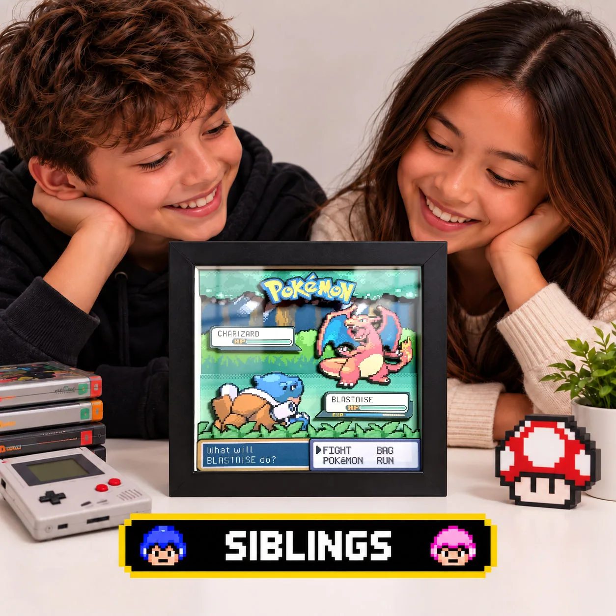 Brother and sister looking at a personalised Pokémon battle shadow box with two chosen Pokémon.